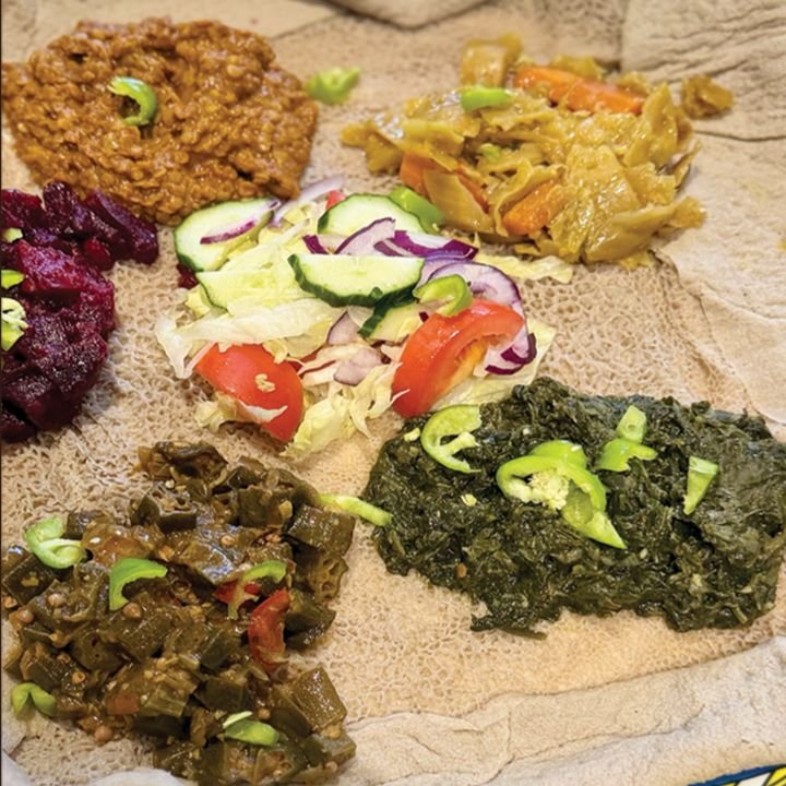 Beb'aynetu — vegan stews, greens and salad on injera